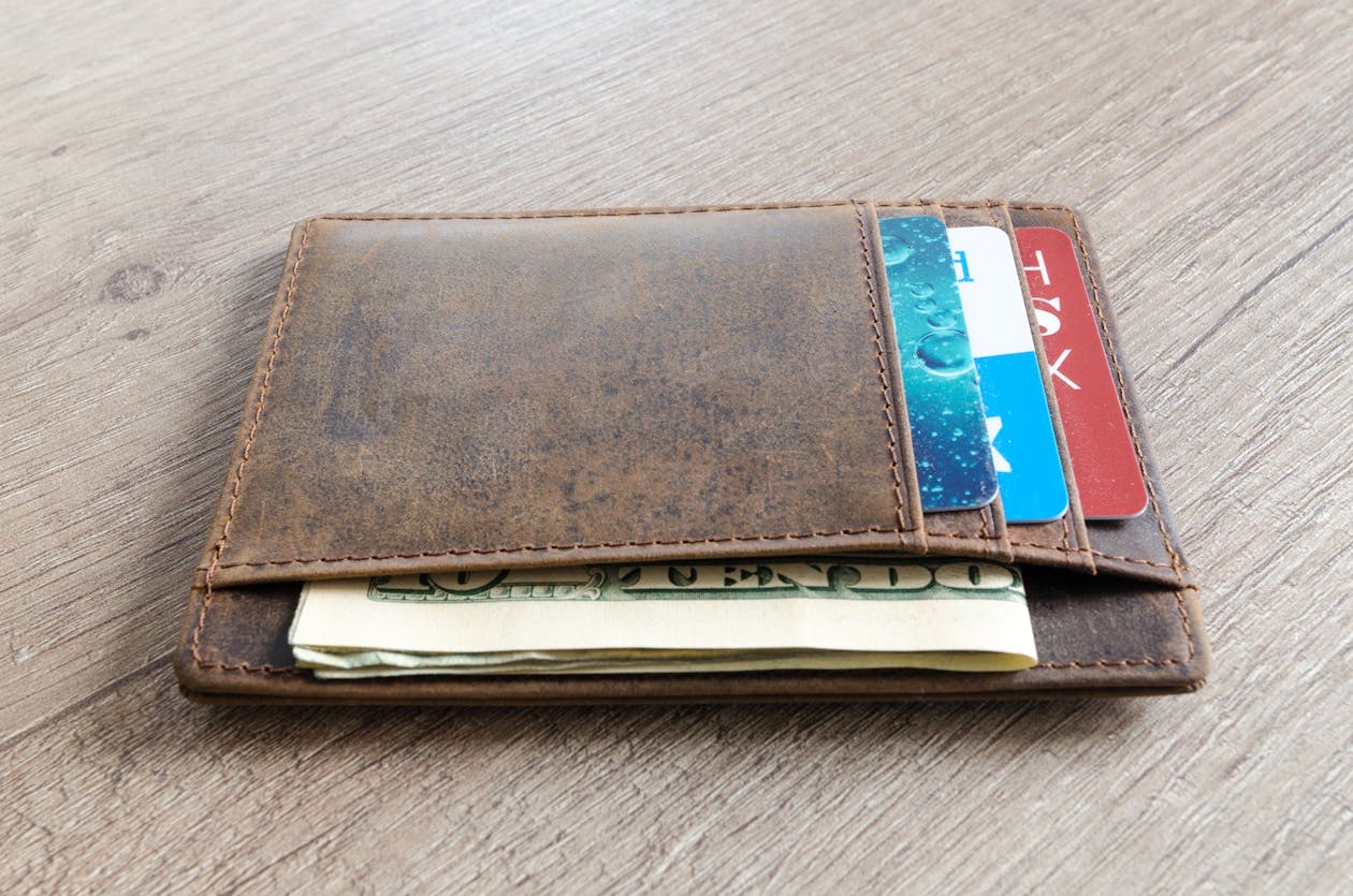 Leather wallet with payment cards and banknotes, a metaphor for retail loyalty programs